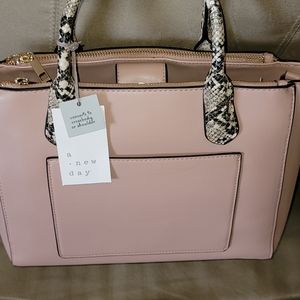 Women's Purse color is like a brush pink. Minor flaws as shown in the picture.